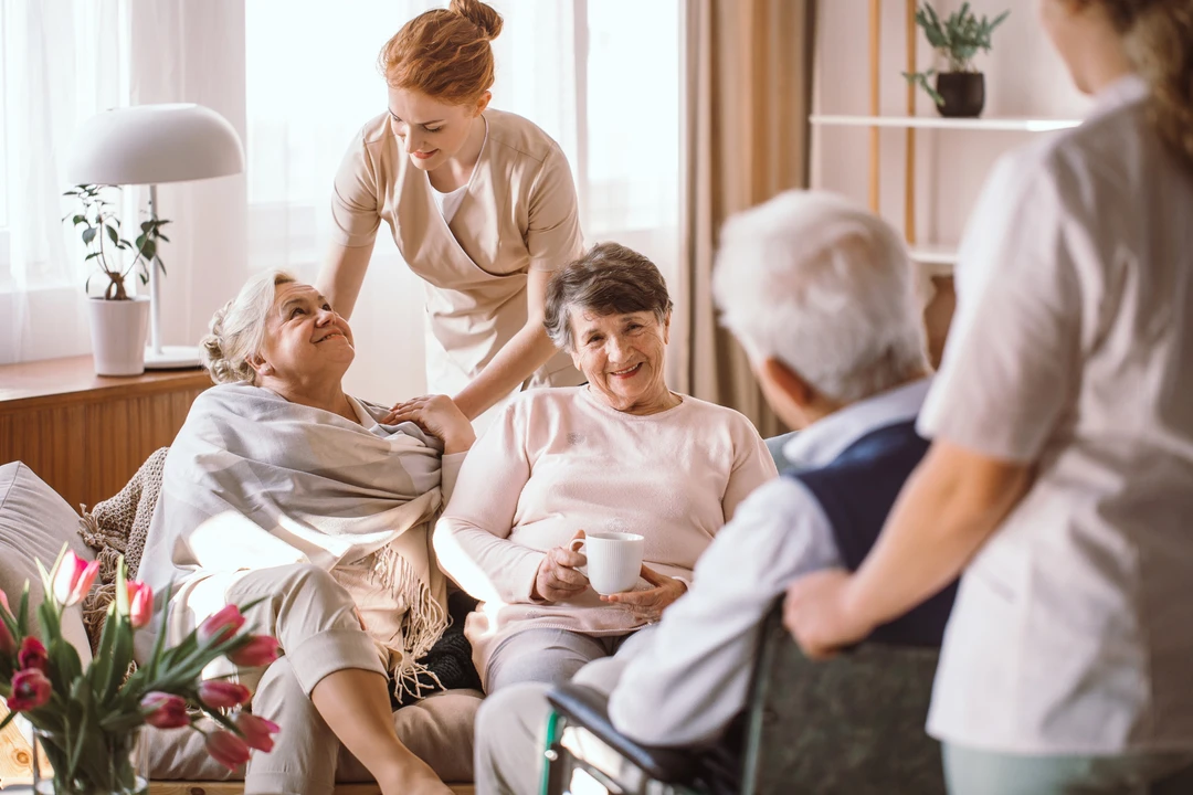 Young caregiver comforting elderly woman in senior home Young caregiver comforting elderly woman in senior home